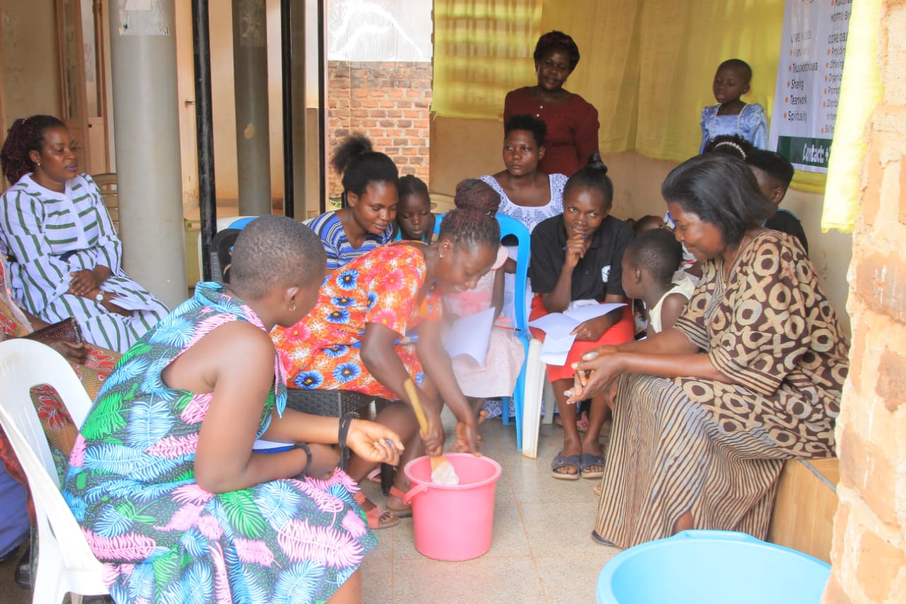 A trainee stirring a mixture while others take notes