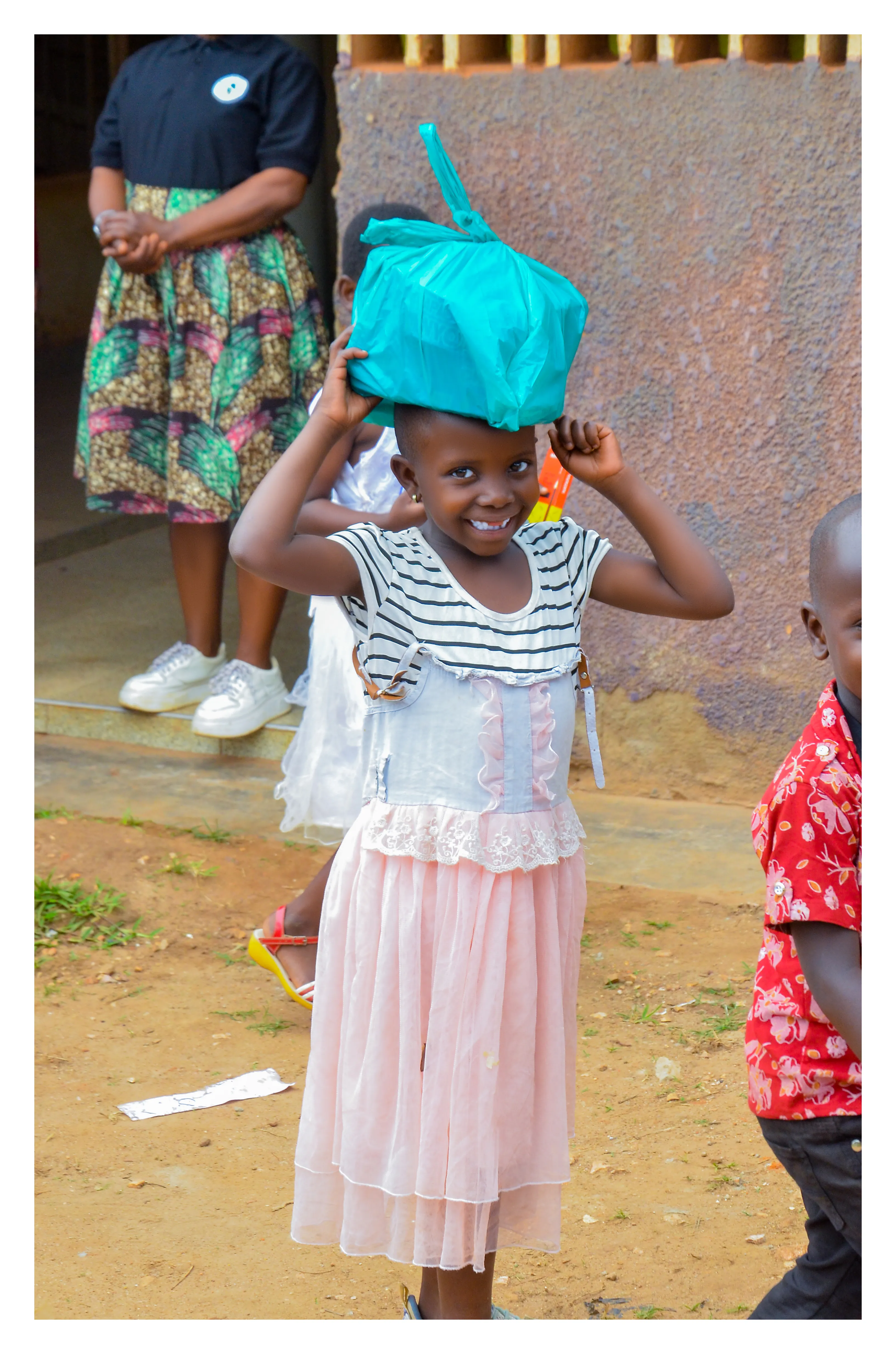 A child carrying a food parcel home