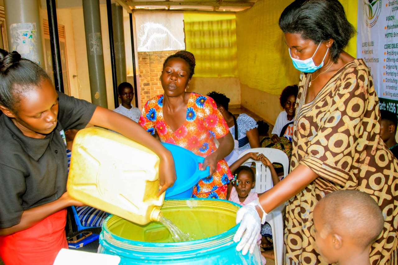 A facilitator demonstrating safe hygiene practice to a group
