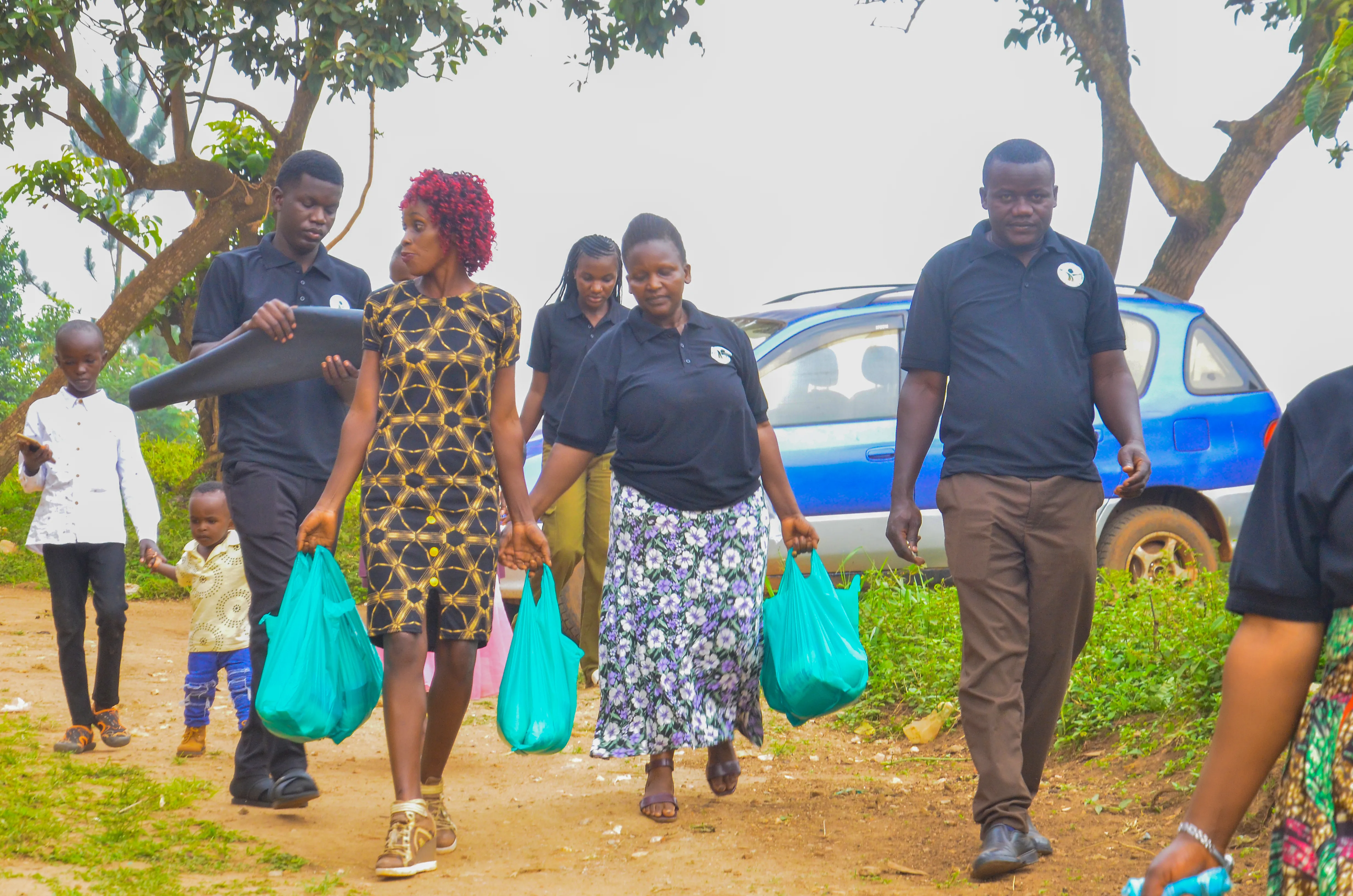 Volunteers walking together carrying supplies
